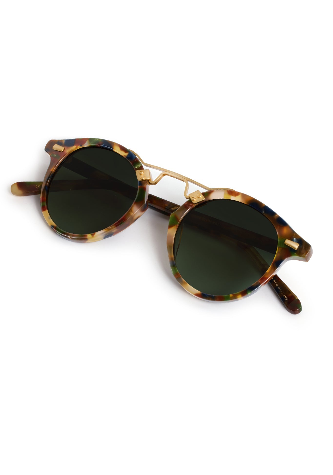 Tortoiseshell sunglasses with gold frames on a white background