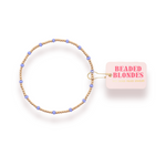 Beaded hair tie with 'Beaded Blondes' label on a white background