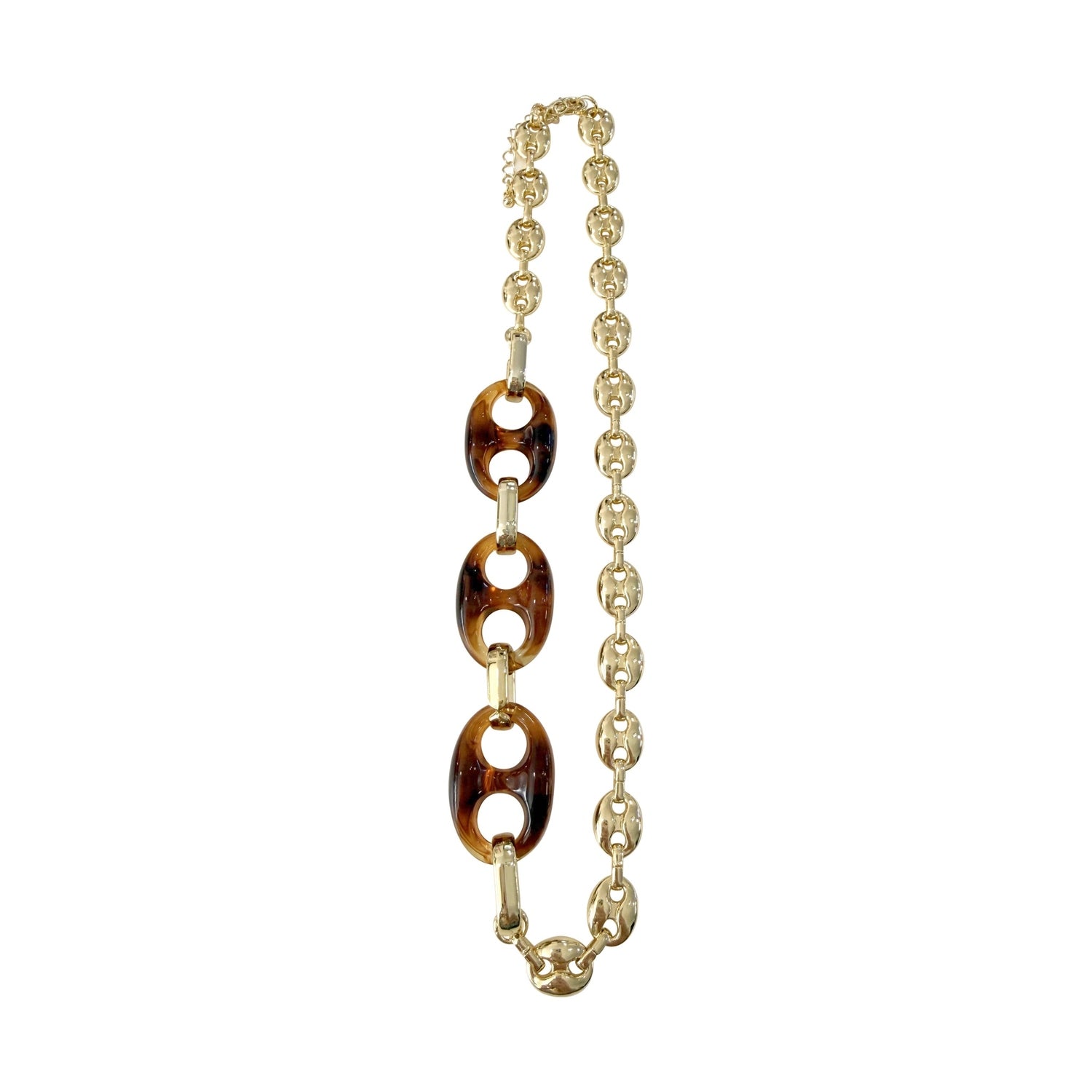 Necklace with tortoiseshell links and gold chain on a white background