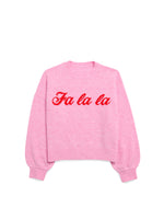 Knit sweater in light pink featuring the festive phrase Fa la la in red cursive script across the chest with a ribbed crew neck and cuffs on a solid white background