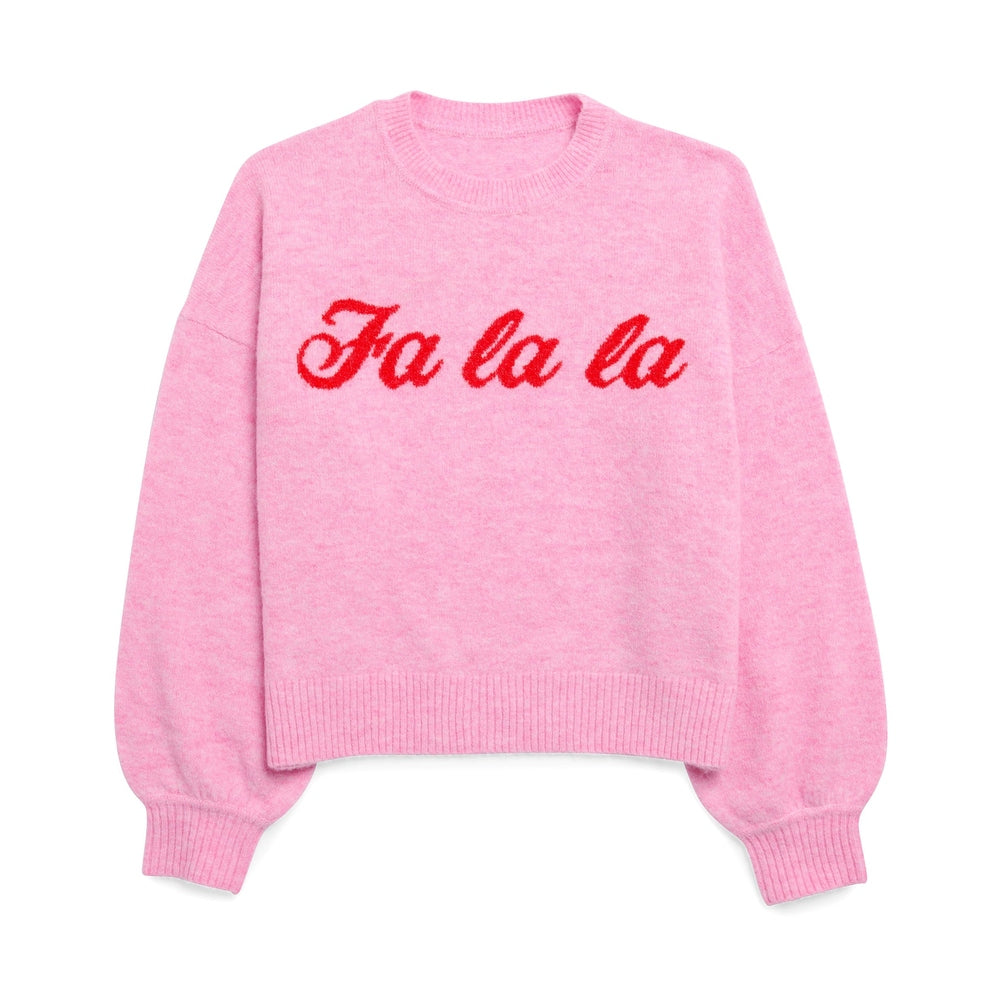 Knit sweater in light pink featuring the festive phrase Fa la la in red cursive script across the chest with a ribbed crew neck and cuffs on a solid white background