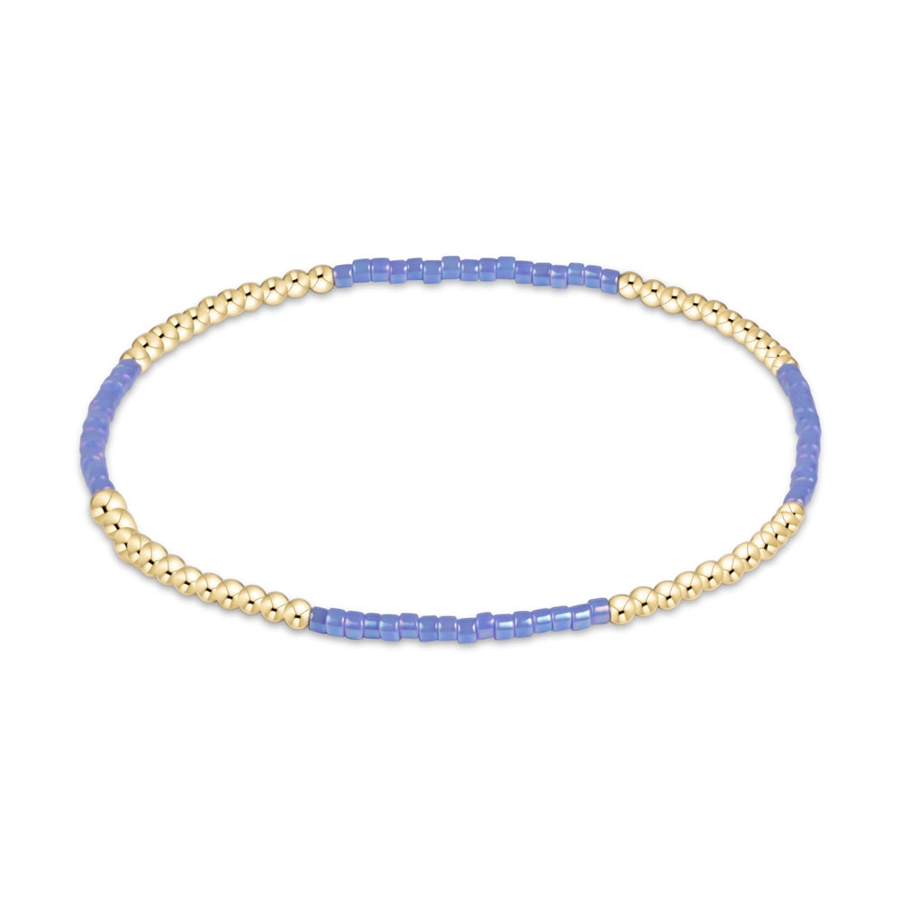 Gold beaded stretch bracelet with periwinkle blue seed bead sections