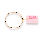 Gold beaded bracelet with black beads on a white background, featuring 'Beaded Blondes' branding.
