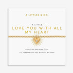Gold beaded bracelet with a sunburst heart charm on a display card with text
