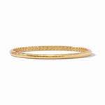 Gold bangle bracelet with hammered texture and geometric interior pattern