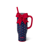 Blue mug with star pattern and red handle, featuring a red bow and straw on a white background.