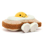 Angled view of a plush fried egg on toast with a smiling yolk face and white feet
