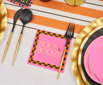 Pink paper napkin with black and orange checkered border and gold text reading Boos and Booze on a table setting