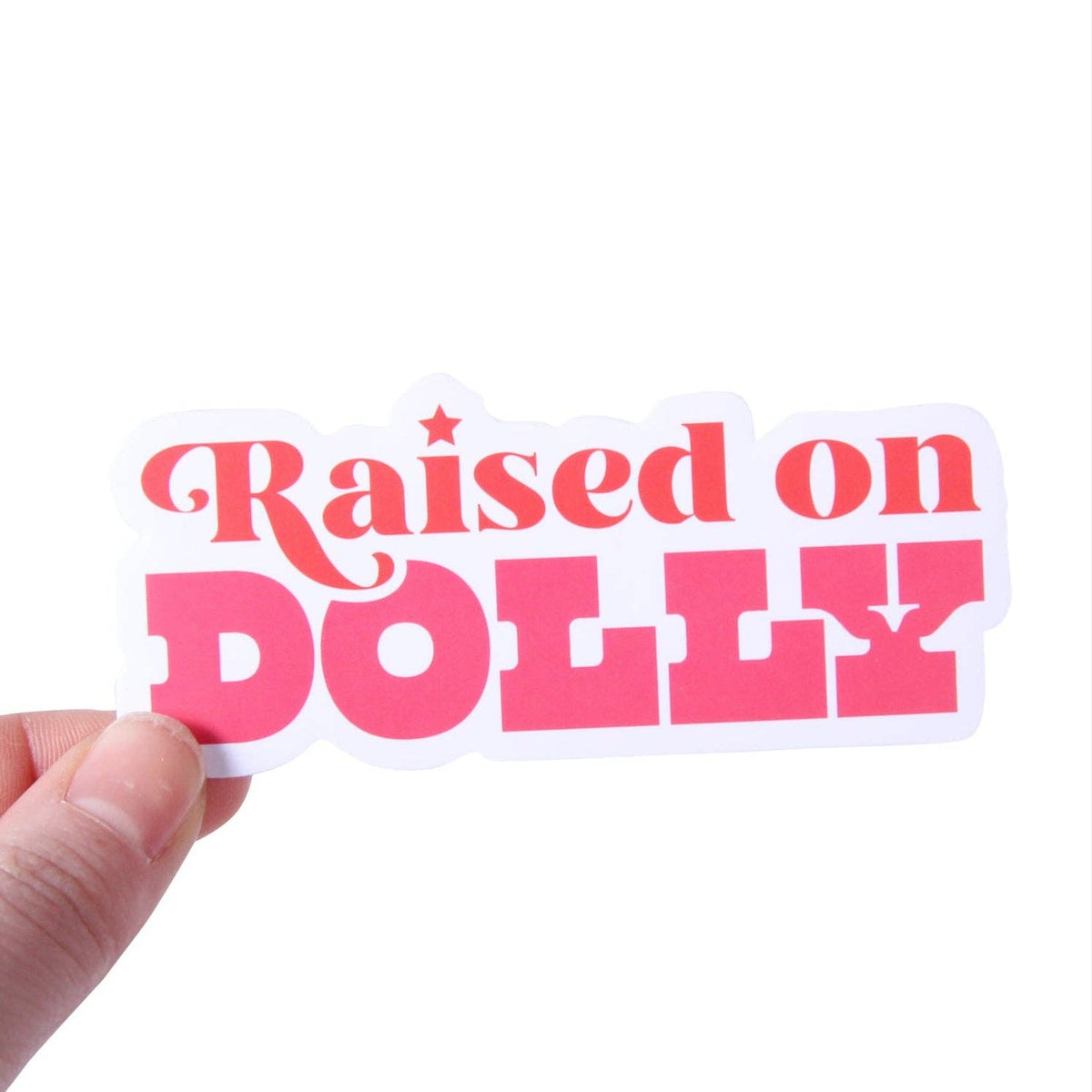 Hand holding a pink Raised on Dolly sticker