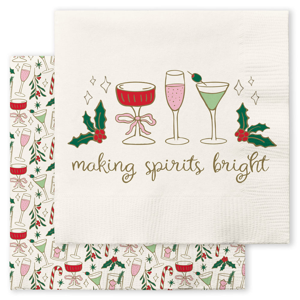Cream cocktail napkin reading "making spirits bright" with cocktails and holly, over a print napkin