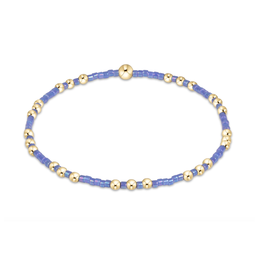 Gold beaded stretch bracelet with periwinkle seed bead sections