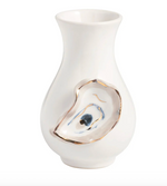 White ceramic vase with a decorative shell design on a white background