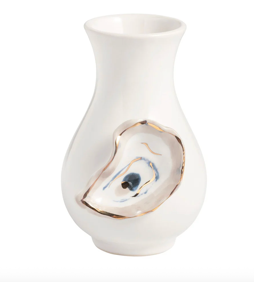 White ceramic vase with a decorative shell design on a white background