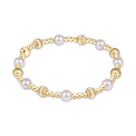 Stretch bracelet with alternating gold beads and white pearls