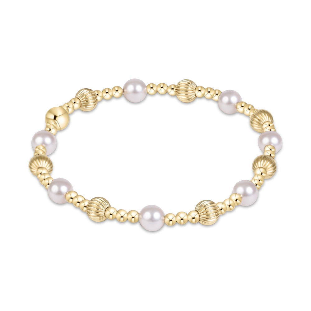 Stretch bracelet with alternating gold beads and white pearls