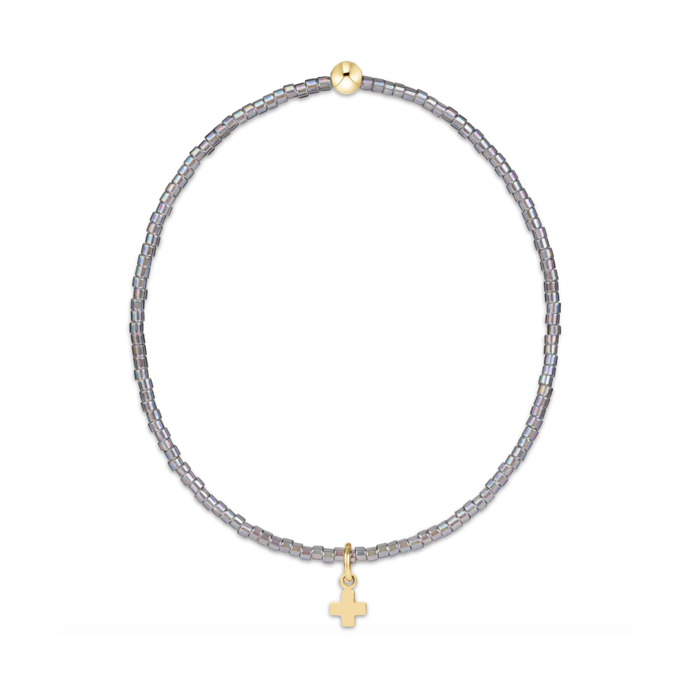 Gray seed bead stretch bracelet with a gold bead and small gold cross charm