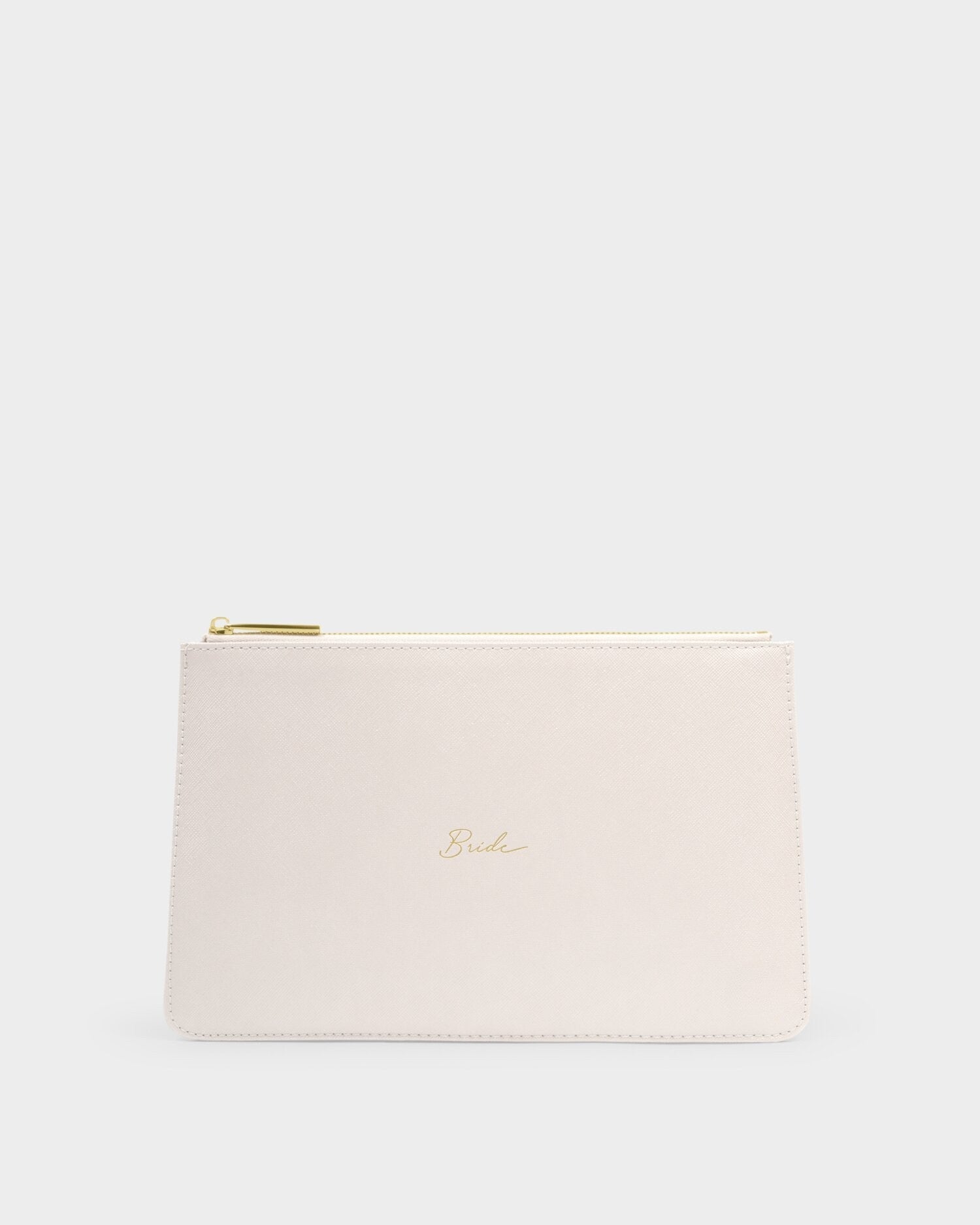 Studio photograph of a cream-colored saffiano leather bridal clutch centered on a neutral gray background featuring delicate gold cursive script reading Bride and a matching metallic zipper pull
