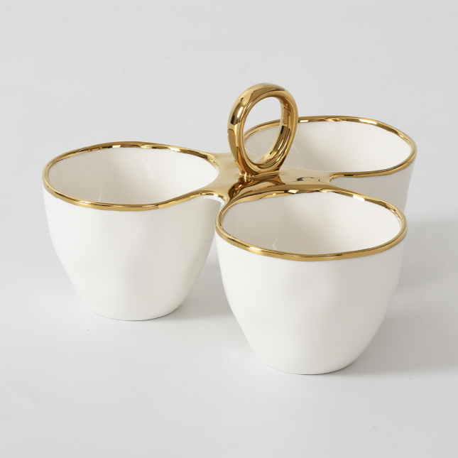 Ceramic white porcelain three-sectioned serving dish with elegant gold rims and a central loop handle on a clean white background