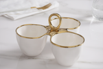 White ceramic three-compartment serving dish with elegant gold trim and a prominent central gold handle resting on a pristine white marble surface