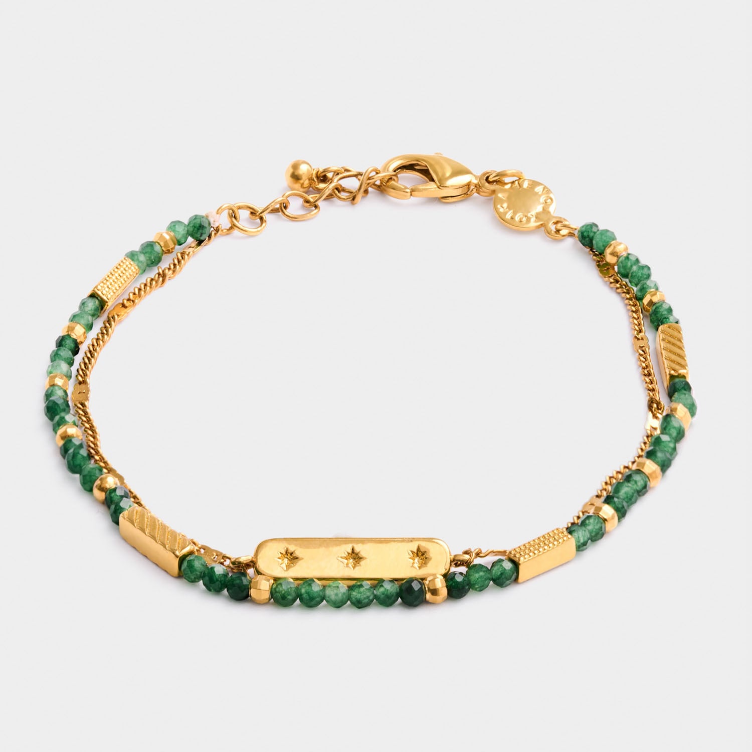 Gold chain bracelet with green beads and a central rectangular charm featuring three star engravings