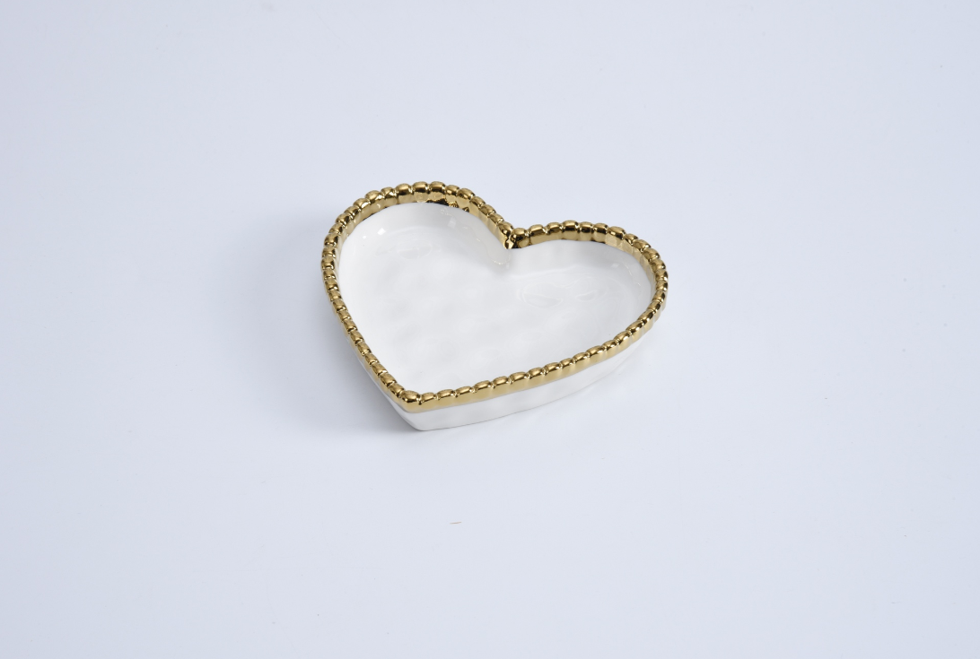 White heart-shaped dish with a beaded gold rim