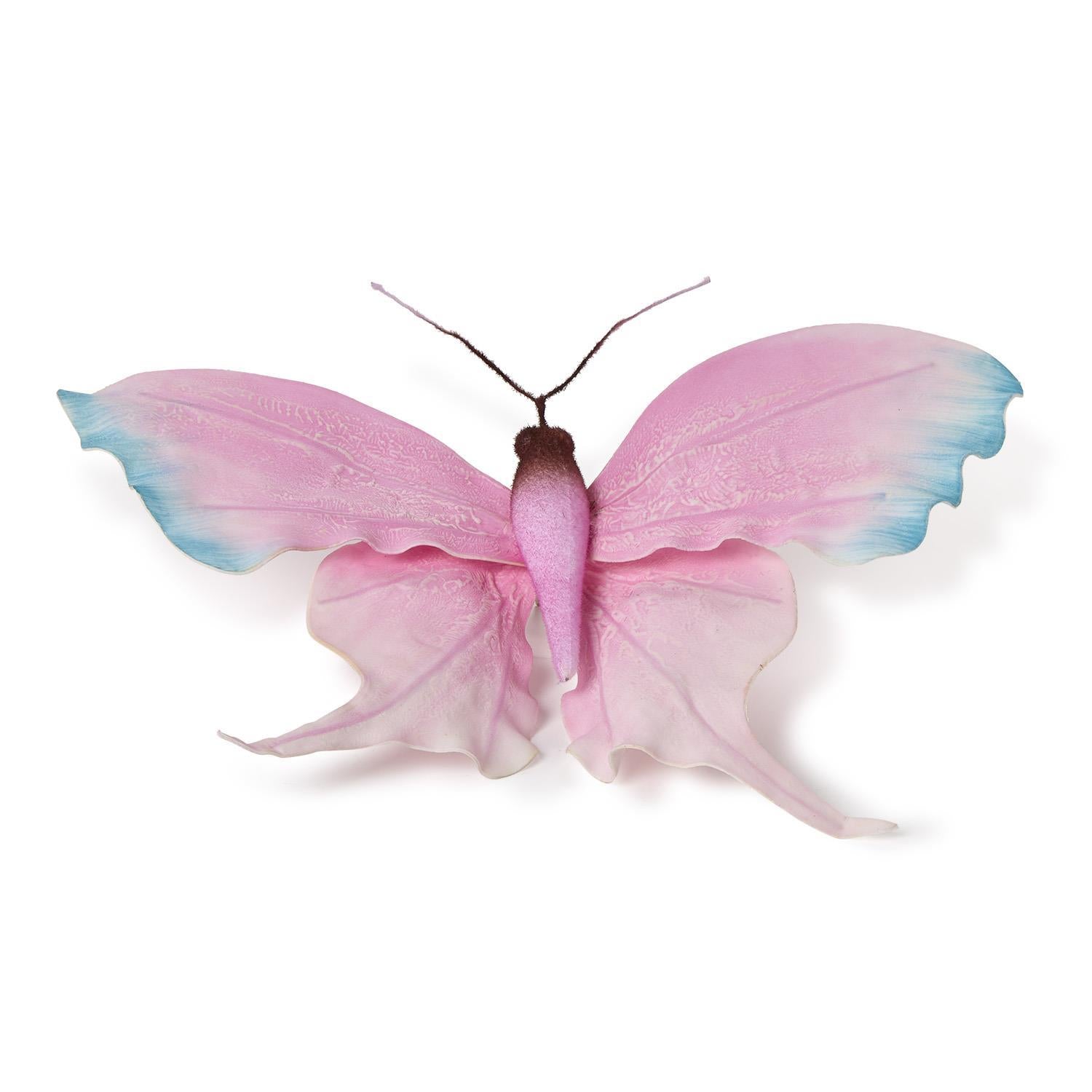 Decorative butterfly featuring translucent pink wings with blue tips, a fuzzy brown body, and elegant long pointed lower wing tails