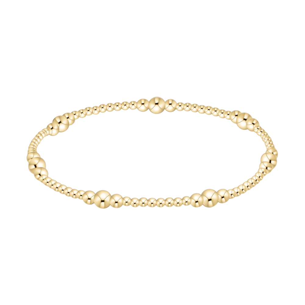 Gold beaded stretch bracelet with varying bead sizes