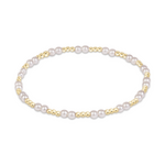 Stretch bracelet featuring alternating gold beads and white pearls