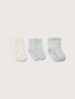a cream sock, a blue solid sock, and a cream and blue striped sock on a taupe background