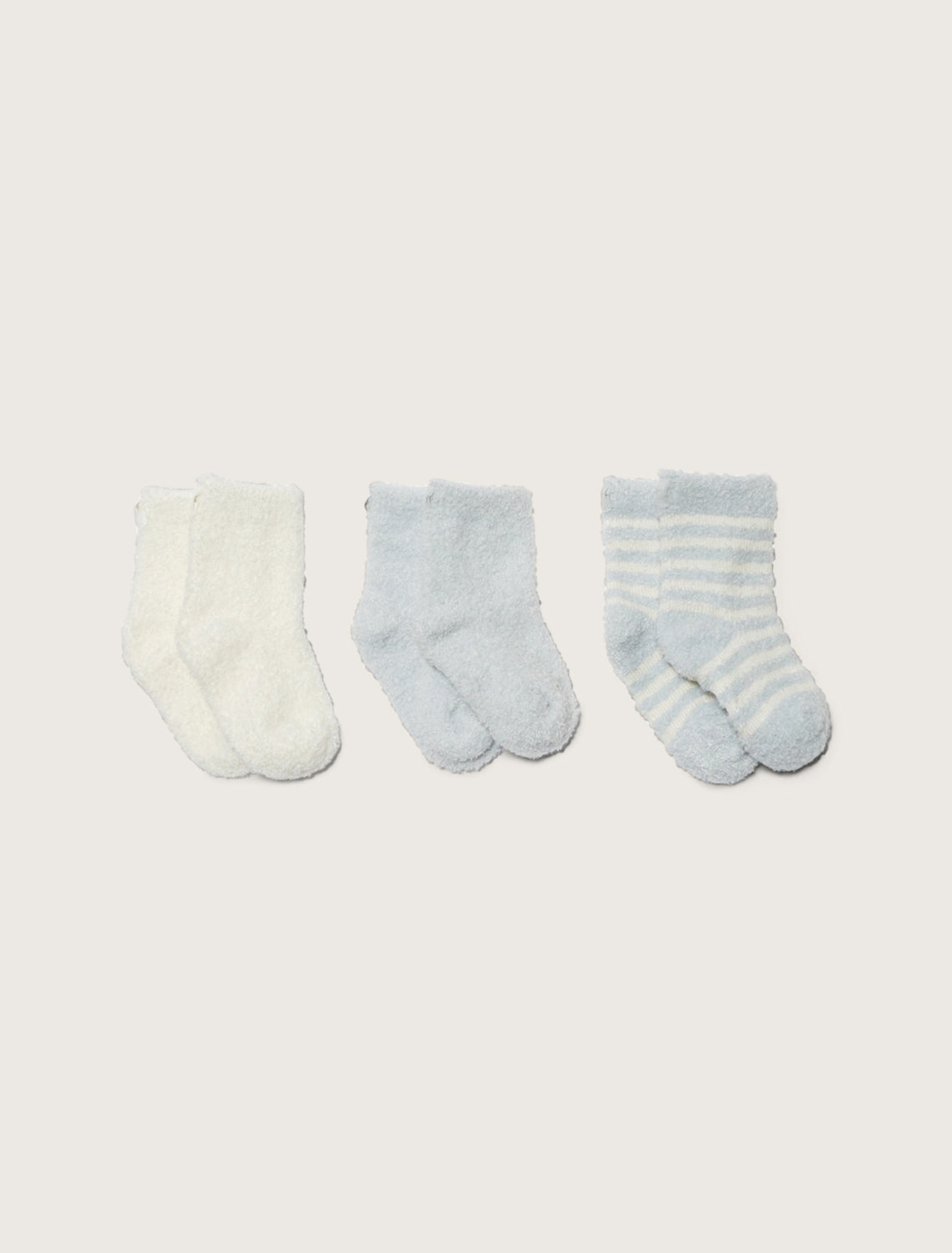 a cream sock, a blue solid sock, and a cream and blue striped sock on a taupe background