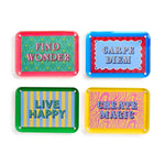 Four vibrant acrylic decorative signs isolated on white, featuring motivational phrases Find Wonder on a green leaf pattern, Carpe Diem on a blue and red checkerboard, Live Happy on blue and yellow stripes, and Create Magic on a pink and yellow zebra swirl pattern