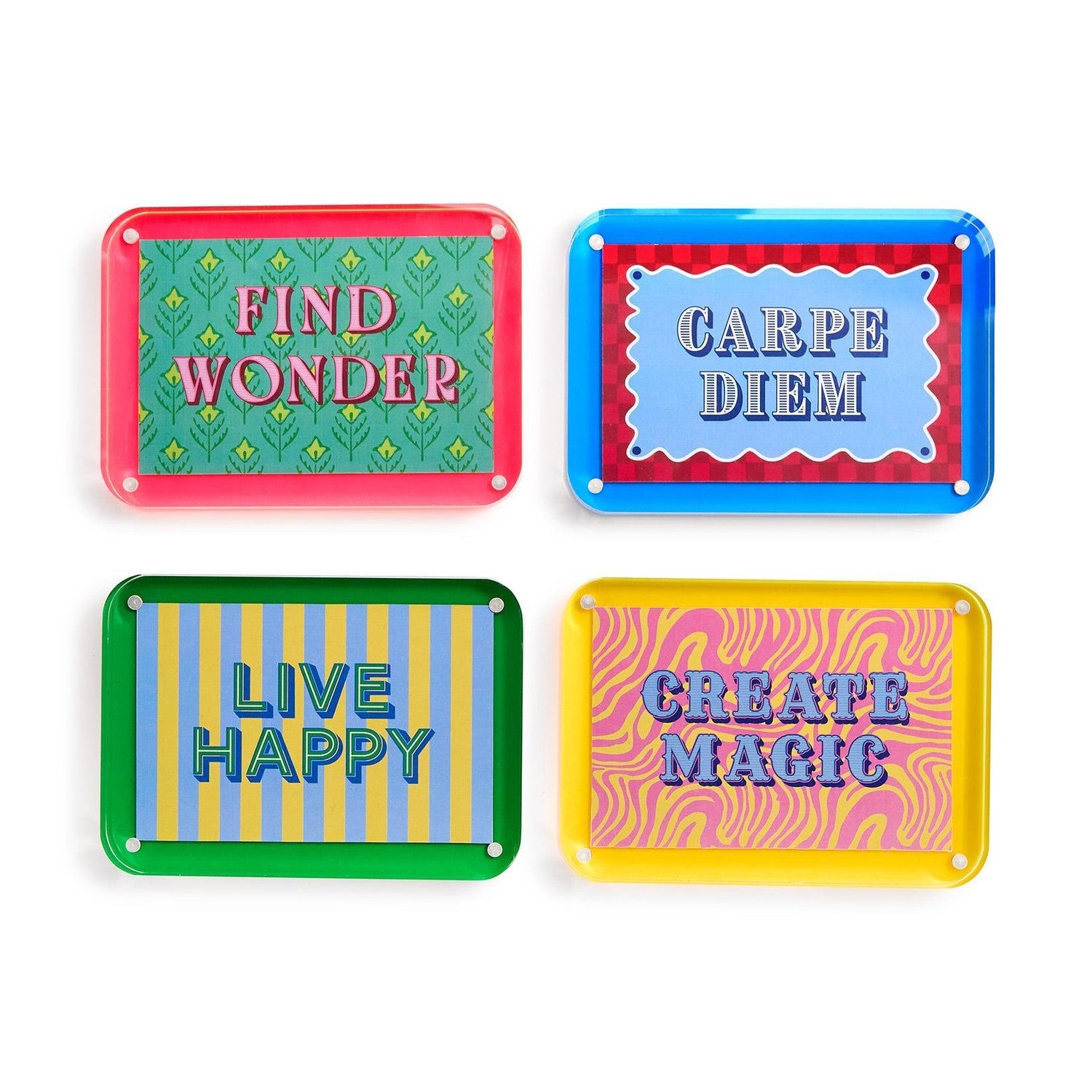 Four vibrant acrylic decorative signs isolated on white, featuring motivational phrases Find Wonder on a green leaf pattern, Carpe Diem on a blue and red checkerboard, Live Happy on blue and yellow stripes, and Create Magic on a pink and yellow zebra swirl pattern