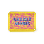 A vibrant yellow acrylic sign featuring blue striped text CREATE MAGIC against a retro pink and yellow wavy background