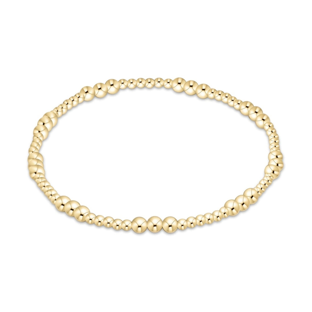 Gold beaded stretch bracelet with varying bead sizes
