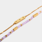 Gold chain bracelet with star engraved bar and beaded bracelet with purple stones and gold accents