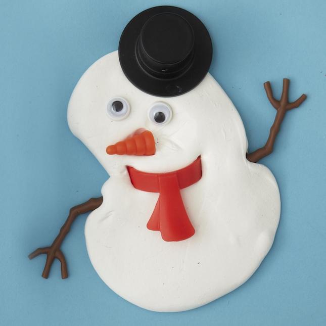 Melted putty snowman with top hat, red scarf and stick arms