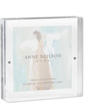 Clear square acrylic frame holding an angel painting card