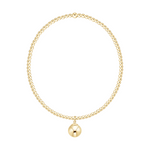 Gold beaded necklace with a single round pendant