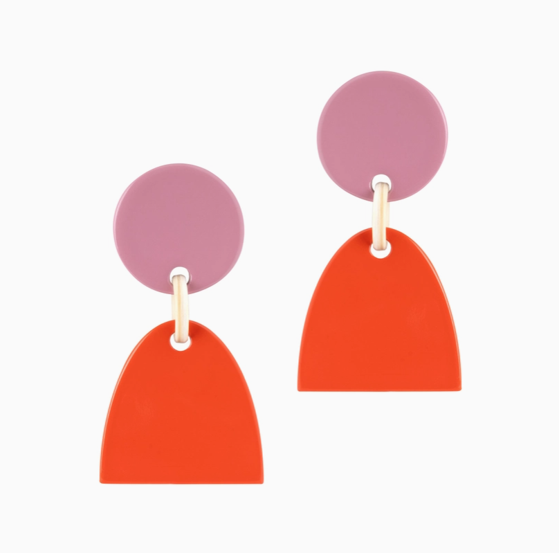 A pair of geometric dangle earrings featuring lilac circle studs and bright orange arch pendants