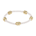 Stretch bracelet with white pearls and gold ribbed beads
