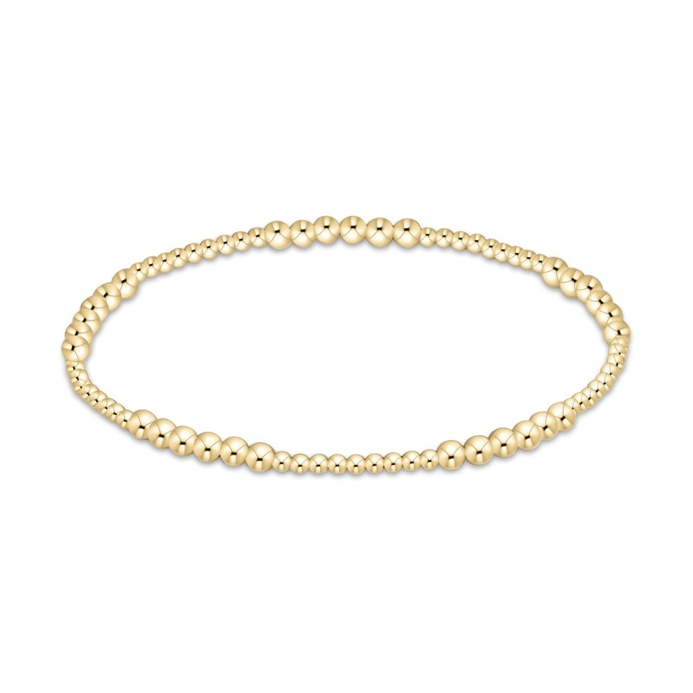 Gold beaded stretch bracelet with varying bead sizes