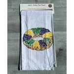 Tea towel with a king cake design in its package