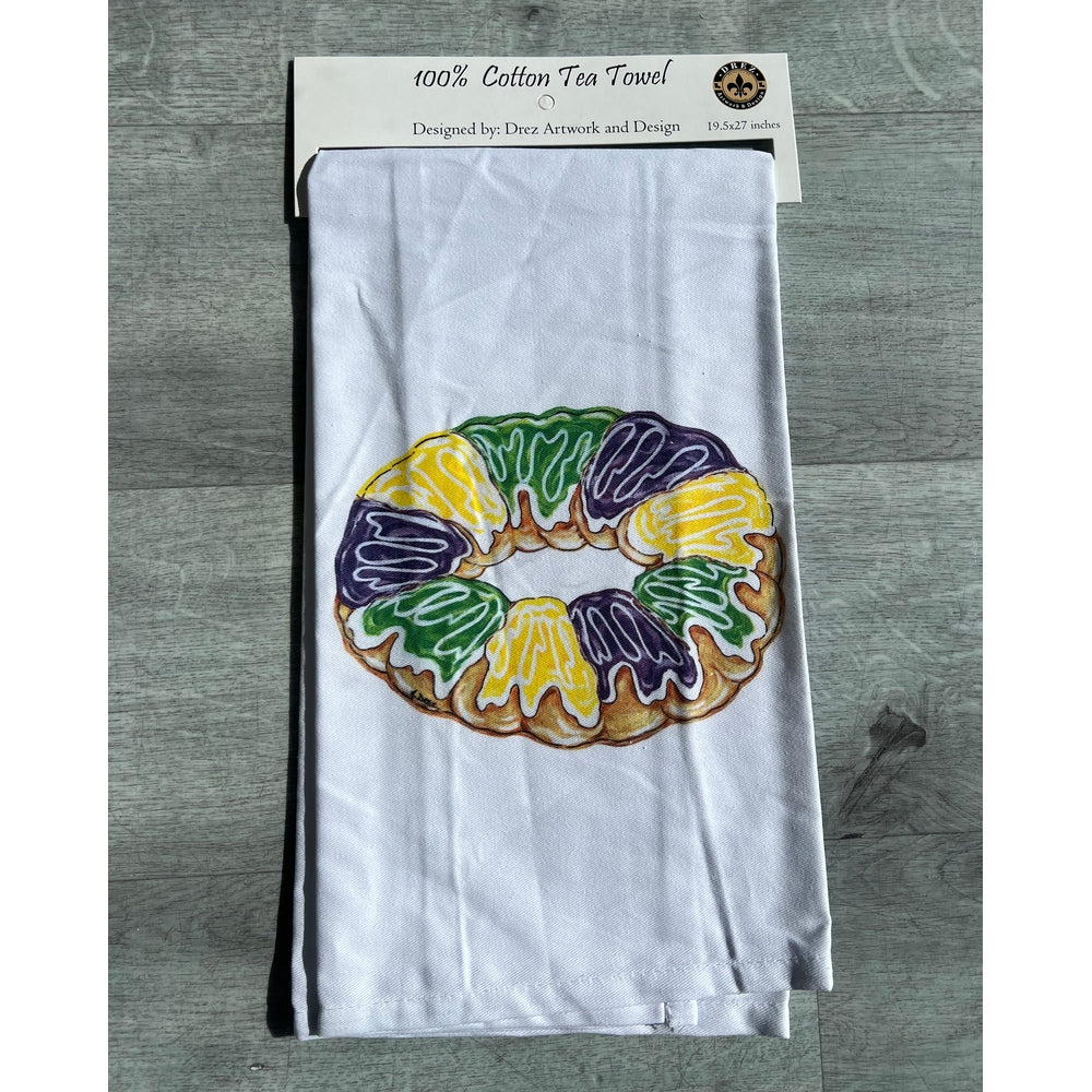Tea towel with a king cake design in its package