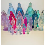 Colorful acrylic figures of the Virgin Mary on a white background