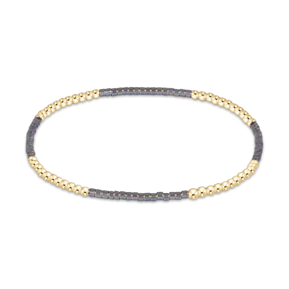 Gold beaded stretch bracelet with charcoal gray seed bead sections
