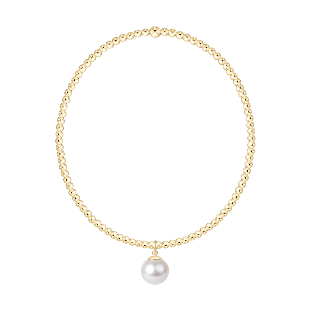 Gold beaded necklace with a single white pearl pendant