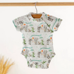 Baby onesie with zoo animal pattern on a hanger against a white background