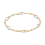 Gold beaded stretch bracelet with evenly spaced white pearls