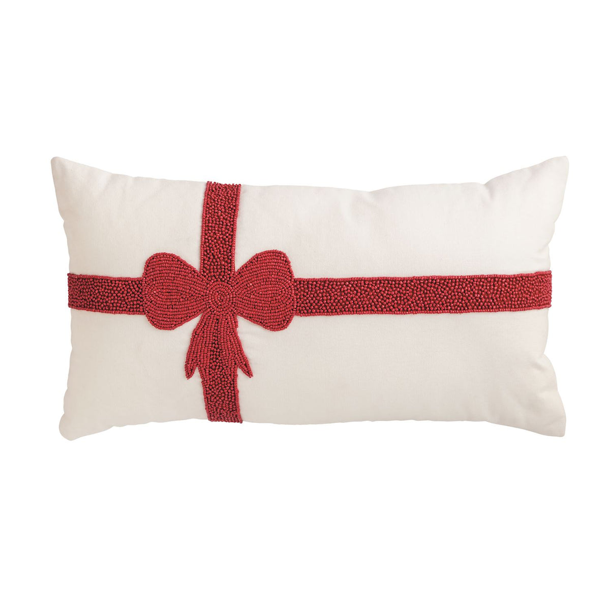 White lumbar pillow with a red beaded ribbon and bow