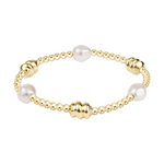 Gold beaded stretch bracelet with two white pearls and three textured gold accent beads